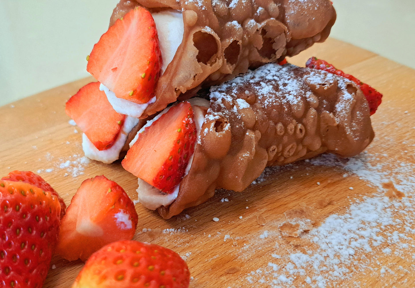 Golden and crispy cannoli shells, filled with strawberry jam and ricotta cream. The ends are topped with lovely, sweet and bright red strawberry. Finished off with a dusting of icing sugar
