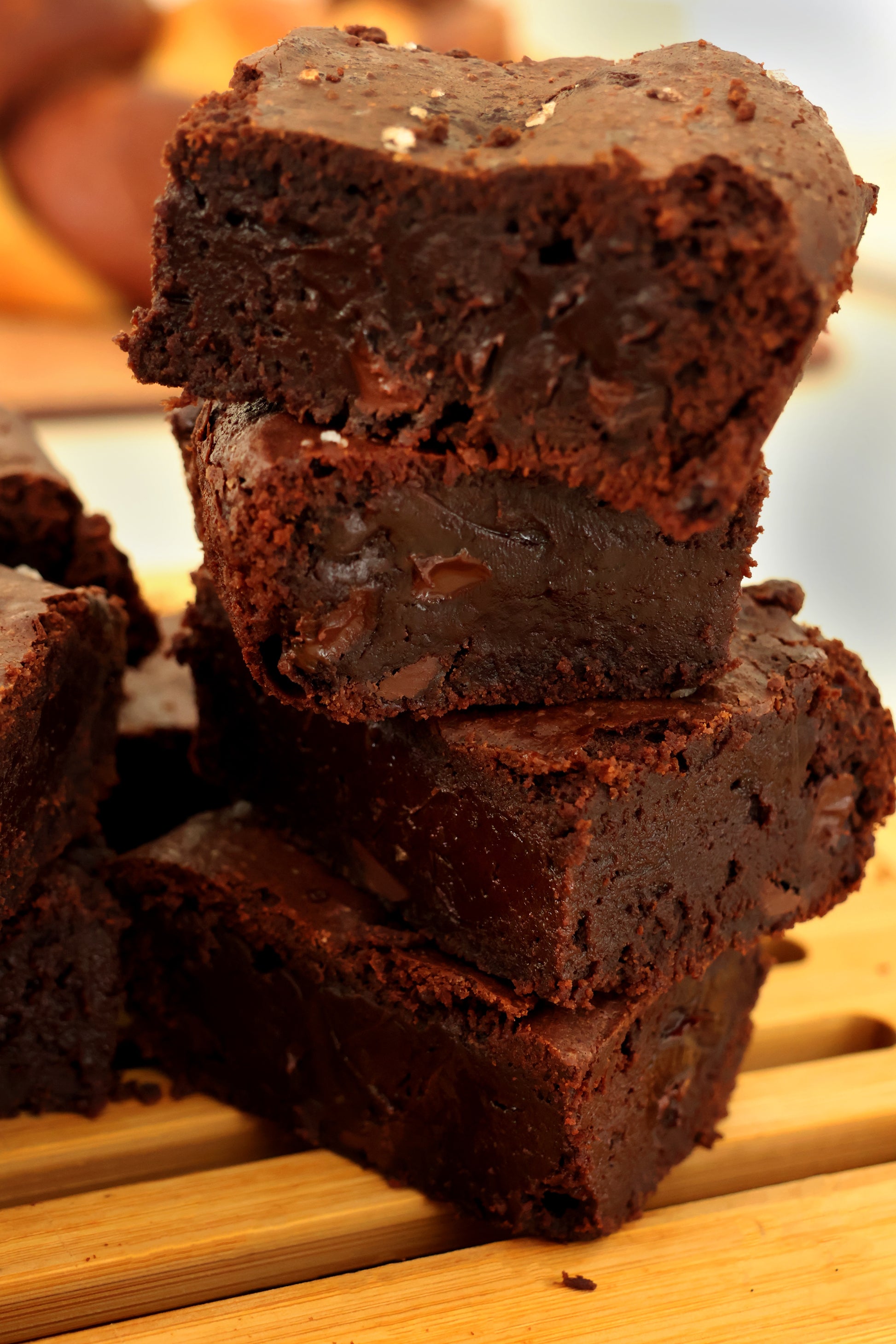 Cross section of the fudgy brownies. Filled with dark chocolate chips and topped with sea salt.