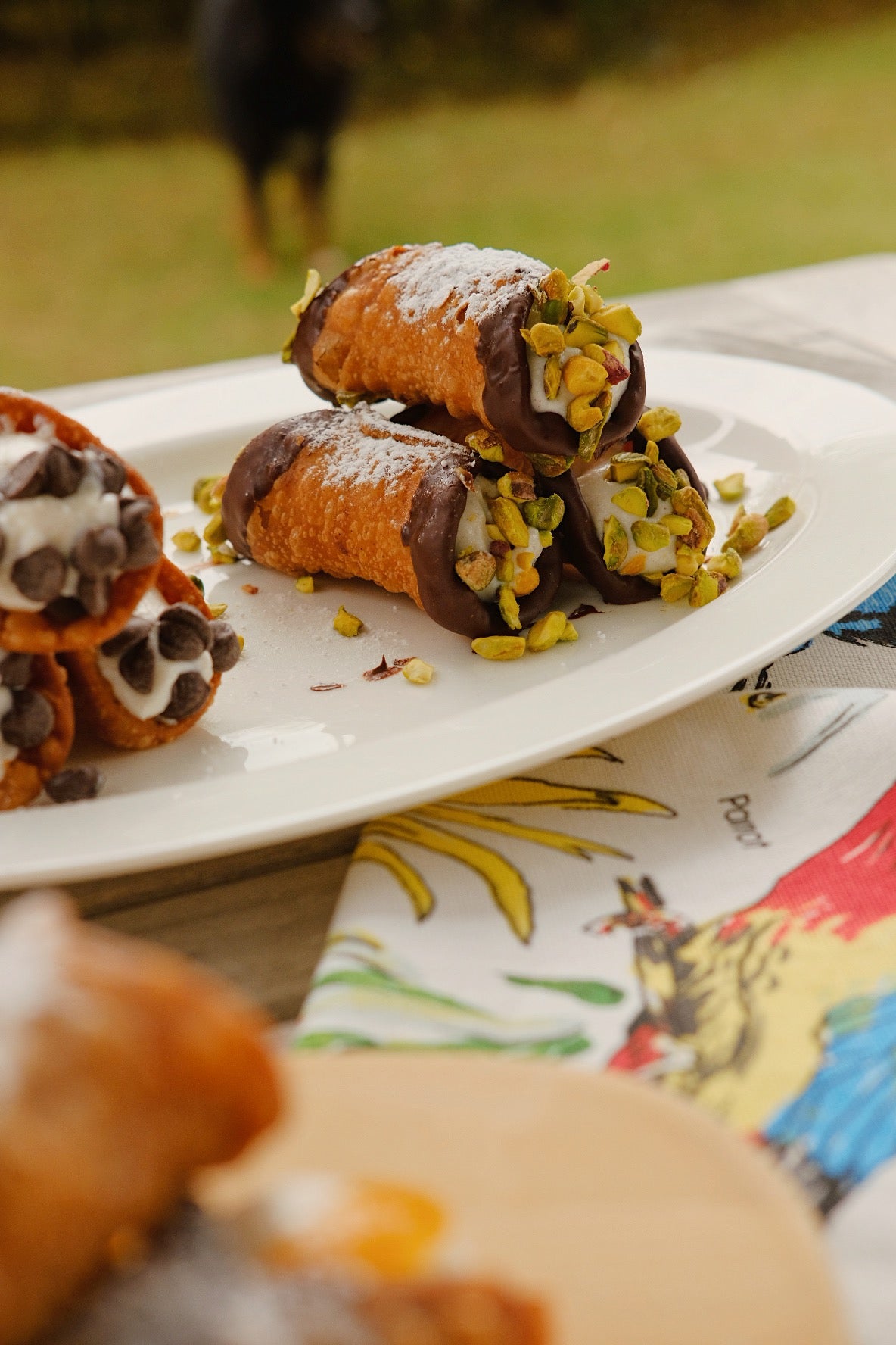 Deep fried Cannoli, Filled with ricotta cream, dark chocolate ends with roasted and crushed pistachios on the ends