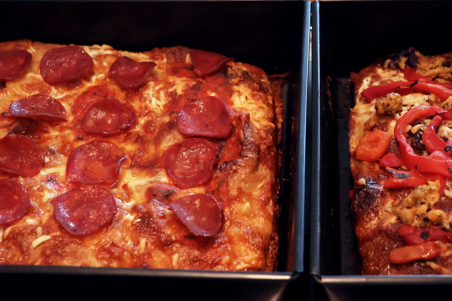 Crispy cheese crusted tray baked pizza. 12 x 8 inches of crispy cheese crusted exterior and a soft and airy interior. Tooped with Pepperoni slices or Sausage met and charred peppers.