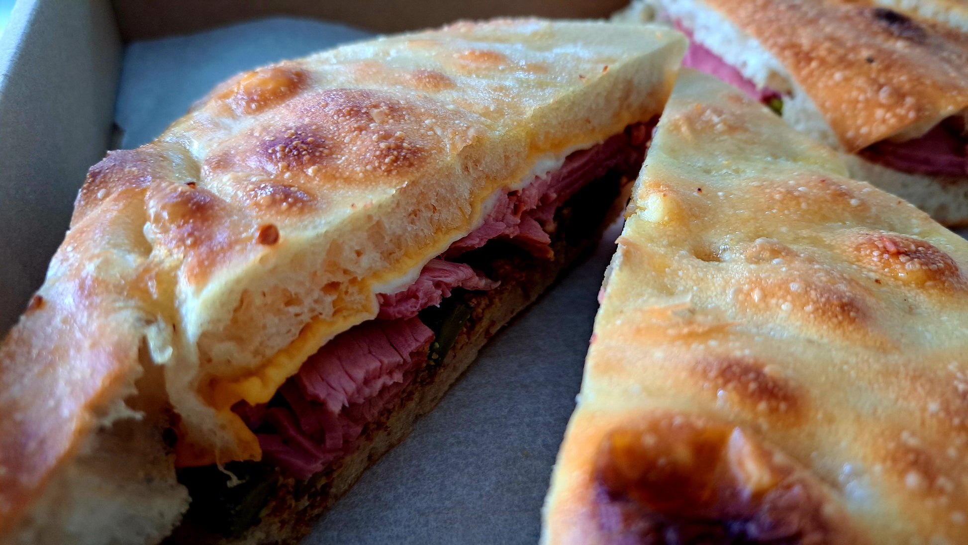 Sink your teeth into a legendary Pastrami Sandwich, piled high with tender, hand-sliced pastrami that's been expertly brined, smoked, and seasoned to perfection. Each succulent layer of juicy, peppery meat is stacked between slices of fresh rye bread, then slathered with tangy mustard for the perfect balance of flavours. Some versions come with melted Gouda cheese, crisp pickles, or a touch of sauerkraut for extra zest. Whether served hot or cold, this hearty, savoury sandwich is a carnivore's dream